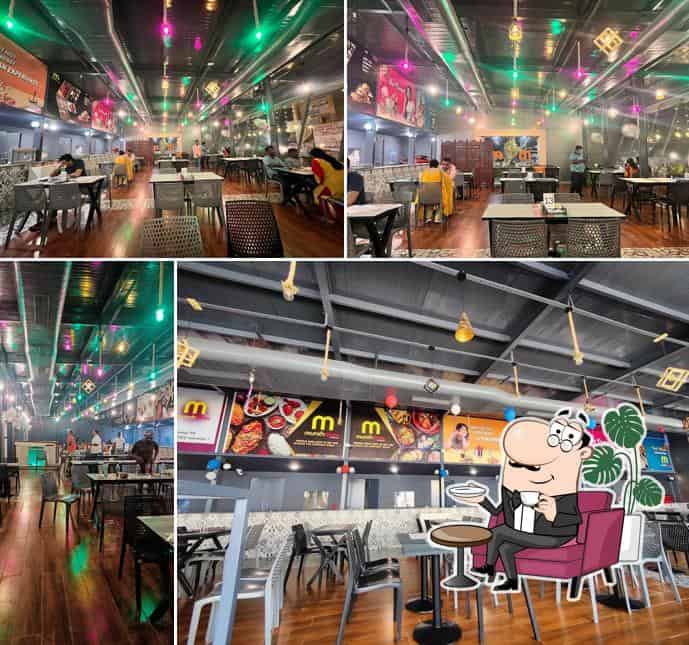 "Modern and cozy interior of Munchooze Restaurant, featuring stylish decor, warm lighting, comfortable seating, and a welcoming dining atmosphere."